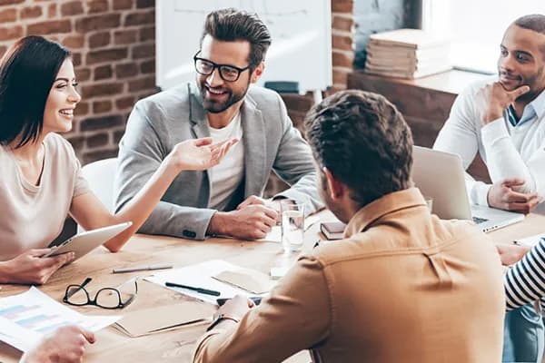A team in discussion around a boardroom table